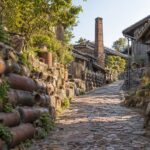 AI-generated illustration of a pottery lane with earthenware pipes, clay jars and a brick kiln chimney, inspired by Tokoname in Aichi, Japan.