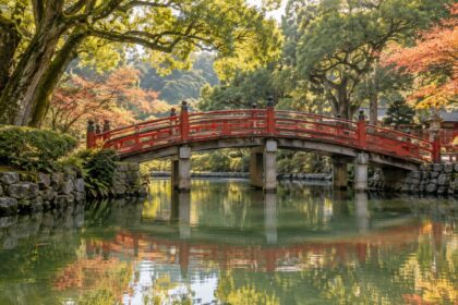 AI-generated illustration of a red arched bridge reflected in a tree-lined pond, inspired by Dazaifu Tenmangu.