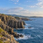 AI-generated illustration of columnar coastal cliffs and blue sea, inspired by Tojinbo in Fukui, Japan.