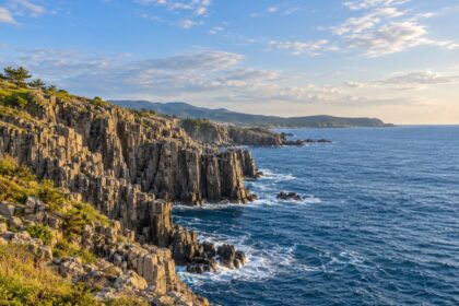 AI-generated illustration of columnar coastal cliffs and blue sea, inspired by Tojinbo in Fukui, Japan.