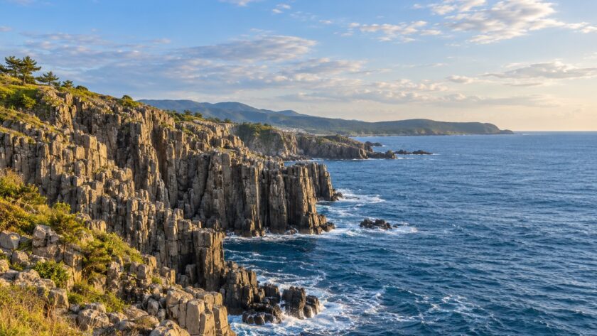 AI-generated illustration of columnar coastal cliffs and blue sea, inspired by Tojinbo in Fukui, Japan.