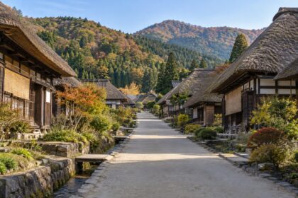 AI-generated illustration of thatched-roof houses beside a quiet village lane, inspired by Ouchi-juku, Fukushima, in autumn.