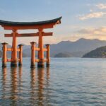 AI-generated illustration of a vermilion torii gate standing in calm sea water with distant wooded hills, inspired by Miyajima in Hiroshima.