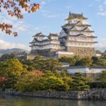 AI-generated illustration of a white Japanese castle with layered tiled roofs and stone walls, inspired by Himeji Castle in Hyogo.