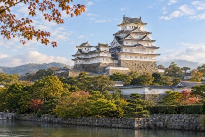 AI-generated illustration of a white Japanese castle with layered tiled roofs and stone walls, inspired by Himeji Castle in Hyogo.