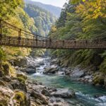 AI-generated illustration of a rustic vine suspension bridge above an emerald river in a wooded ravine, inspired by Iya Valley in Tokushima.